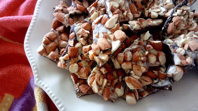 a platter of Toasted Almond Bark next to a red dish cloth