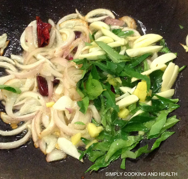 Adding curry leaves ginger and garlic