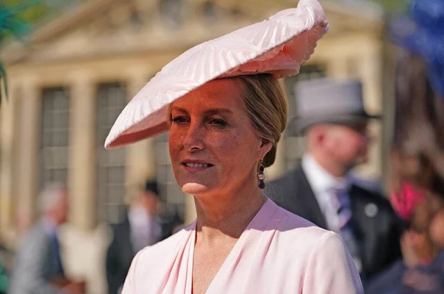 Duchess of Edinburgh wore a salmon pink wrap dress by Suzannah. Princess Anne floral print dress, Duchess of Gloucester gray dress
