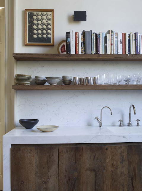 raw wood plank cabinets with a modern marble counter surround paired with open upper kitchen shelves for cookbooks