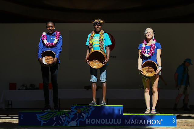 Top 3 finishers of the Women's race on the podium: Renee Metivier of the USA, 3rd place, Margaret Wanguri Muriuki of Kenya 1st place and Betsy Saina of Kenya 2nd place during the Honolulu Marathon 2019 on December 08, 2019 in Honolulu, Hawaii.