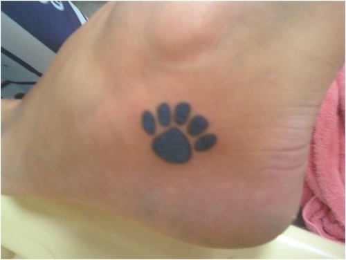 Ankle tattoo of small paw