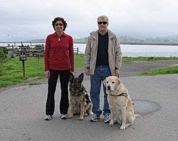 GDB graduates Aerial Gilbert with Guide Dog Splash and Ken Altenburger with Guide Dog Bristol stand together