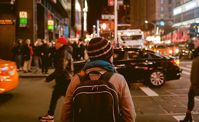 Night street scene of people and cars