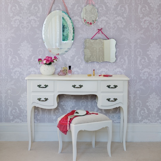 small vanity table with three mirrors and storage with small stool