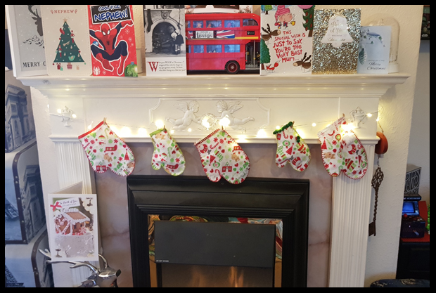 Adding mittens round the fireplace for Christmas