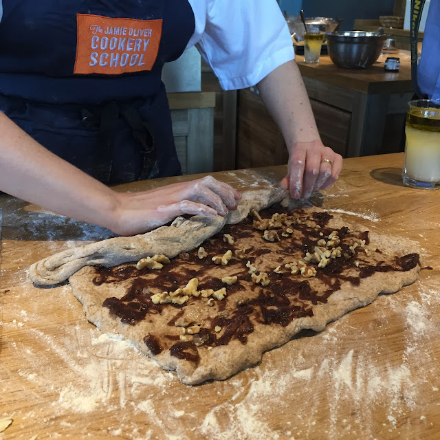 Jamie Oliver Cookery School chef rolling up her picnic loaf