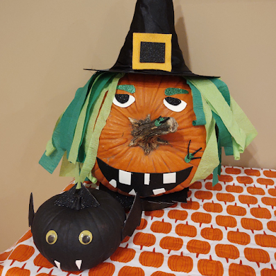Photo of pumpkin decorated as a witch and bat