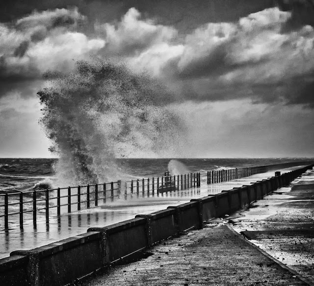 Photo of a towering wave whipped up by high winds by Maryport Promenade