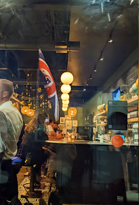 Photo of a British Pub with abstract reflections in view.