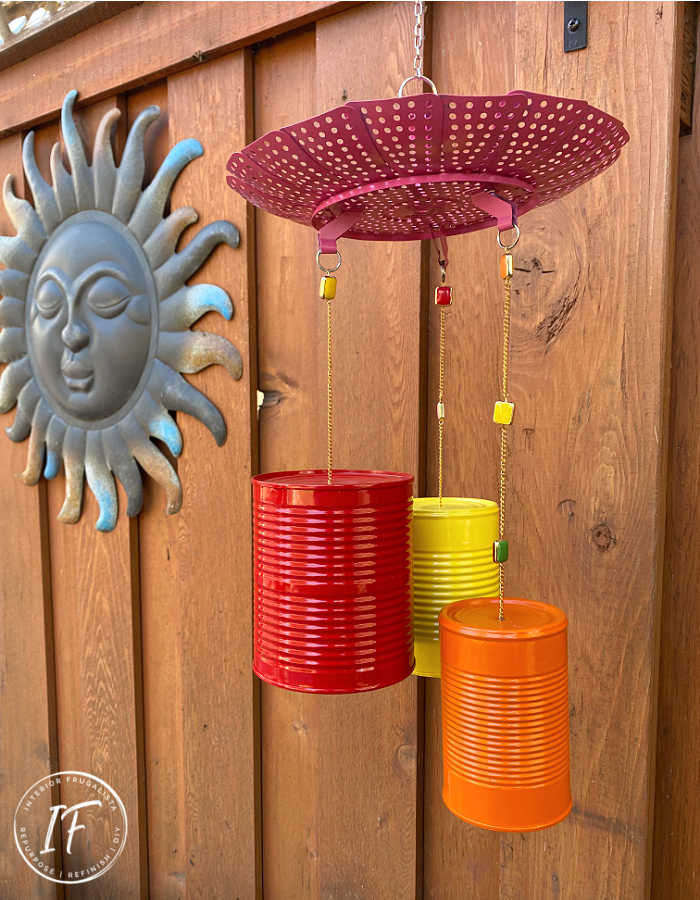 How to make bright and whimsical Upcycled Tin Can Wind Chimes with recycled food cans, a vintage strainer, and old necklace for unique garden decor.