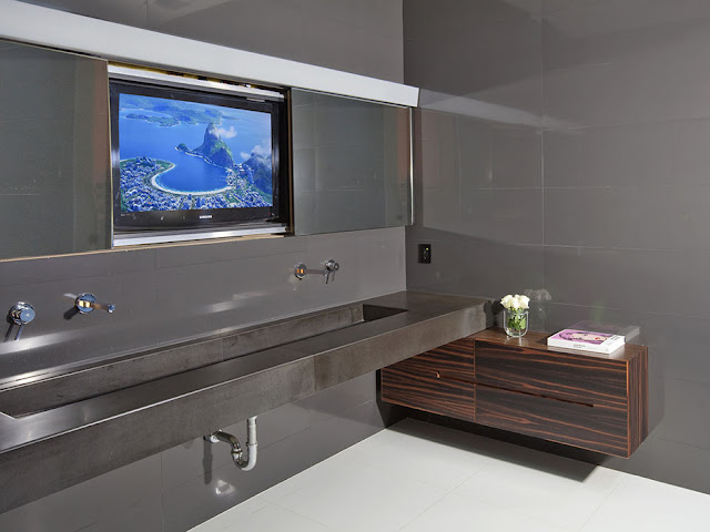 Photo of large tv on the wall of modern bathroom 