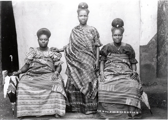 Fante (Fanti) woman wearing a cloth decorated with swastikas (nkontim).