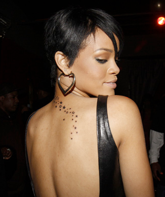 Girl Celebrity Tattoos From Rihanna on Back With Star Design