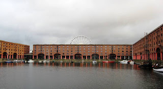 Dock buildings with a glimpse of Ferris wheel