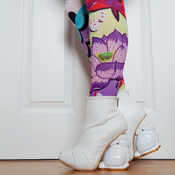 wearing plain white ankle boots with bunny shaped heel to paint and colourful printed tights