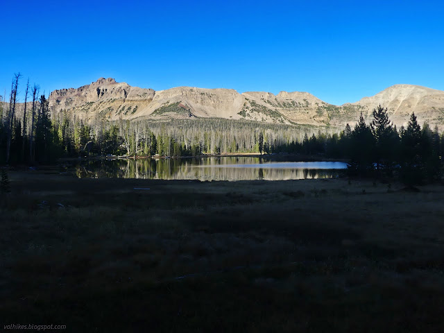 134: lake under sunlit mountains