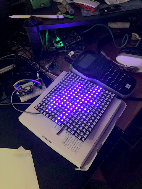 an LED grid showing an octothorpe logo connected to a breadboard