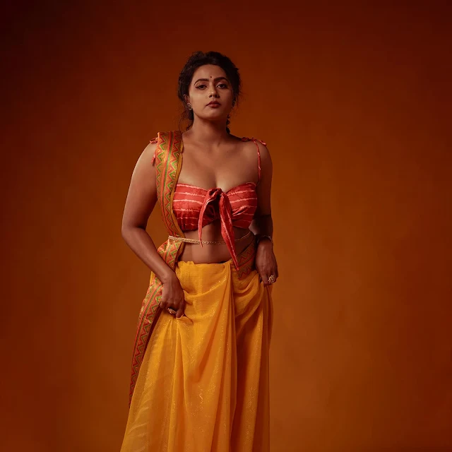 Megha Thomas Hot in Vibrant Yellow Saree and Orange Blouse