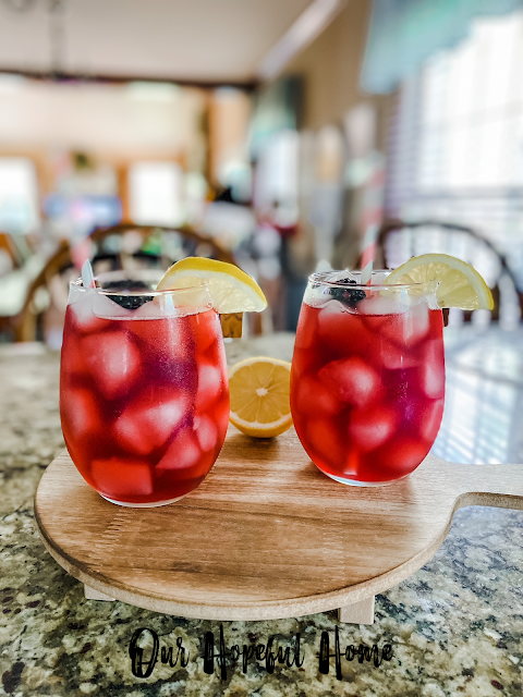 bright red summer drinks with lemons and berries