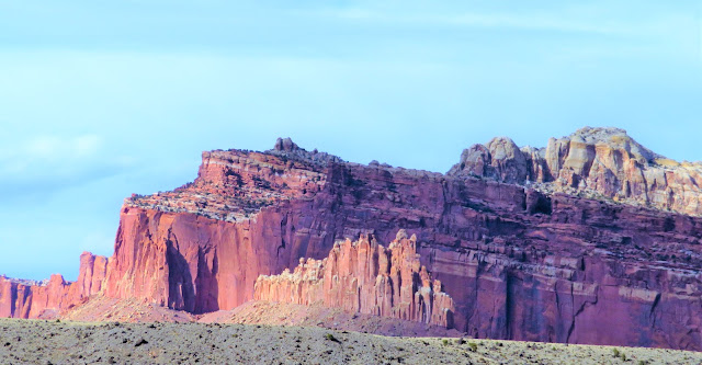 Striped cliffs tilting upwards.