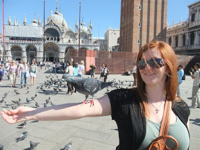 feeding pigeons in st marks square, venice italy