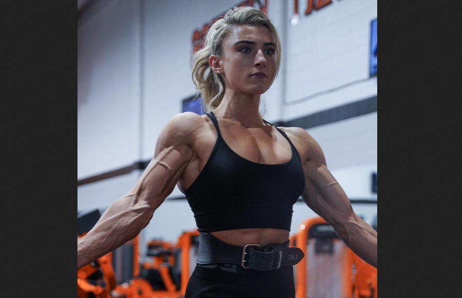 Muscular female bodybuilder in a stunning posing