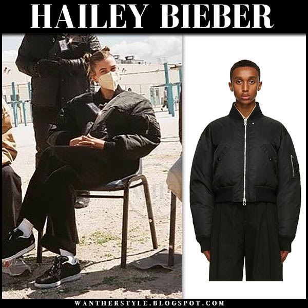 Hailey Bieber in black jacket and black sneakers