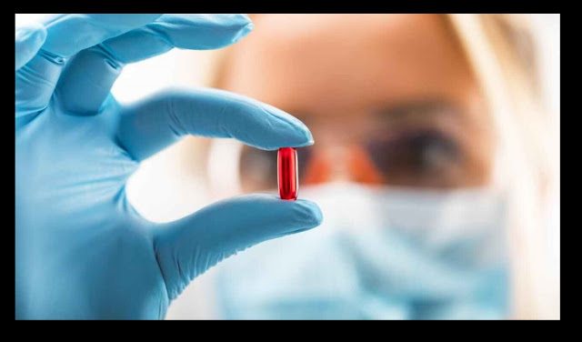 researcher-cancer-holding-red-pill-drug-medicine