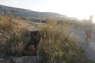 Danielle bathing in a small water channel