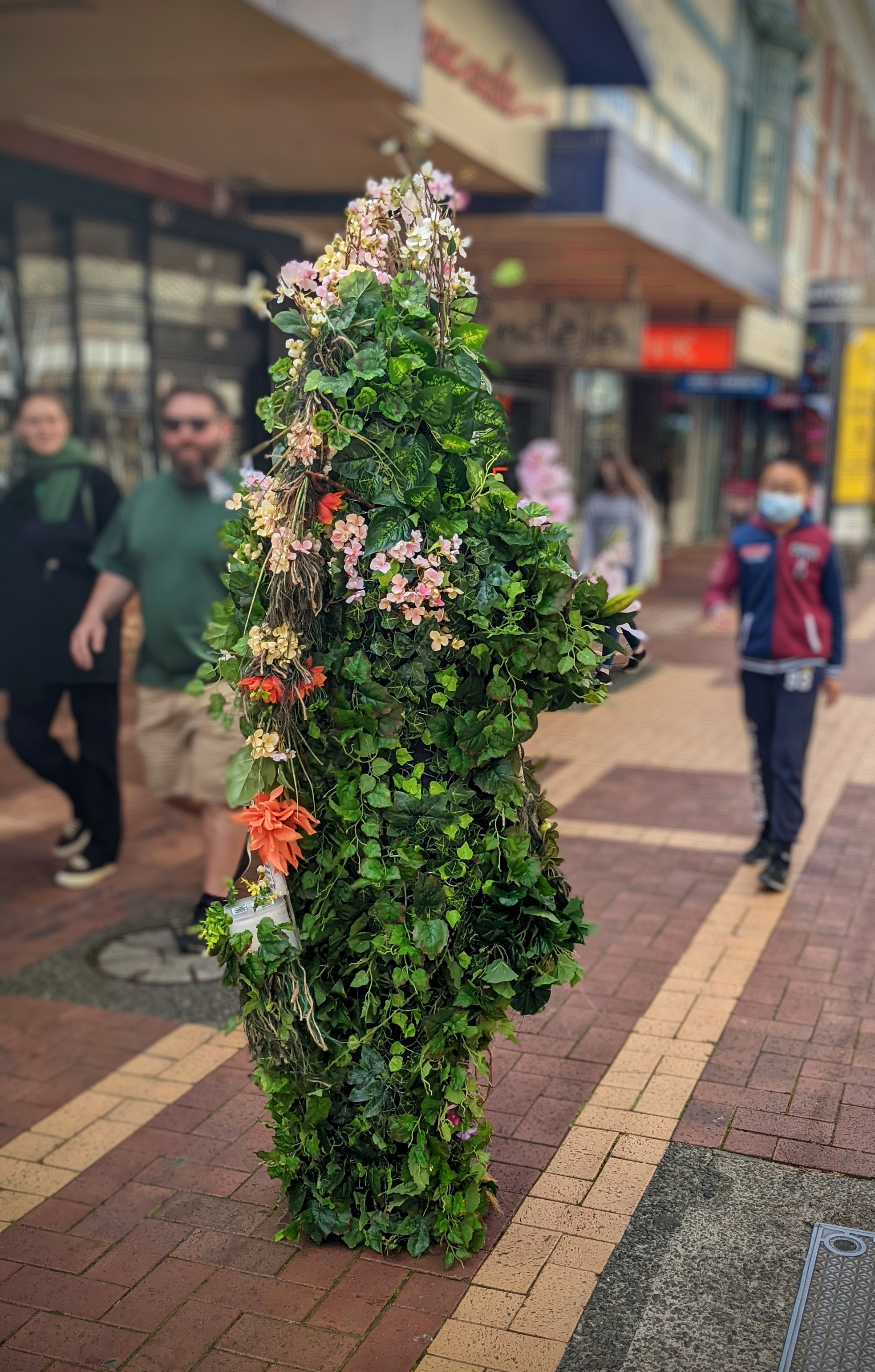 Magic Flute Tree, man dressed as a tree approaches people to talk about environmental issues
