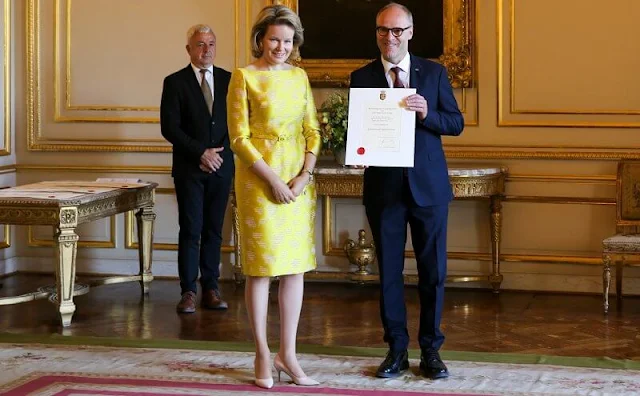 Queen Mathilde wore a yellow embroidered silk satin midi dress by Belgian designer Edouard Vermeulen