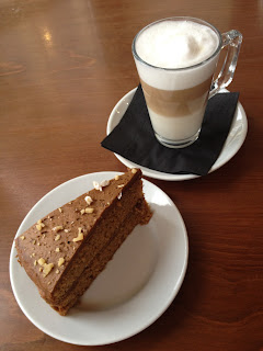 Latte and a slice of coffee and walnut cake