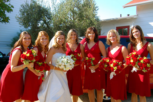 red bridesmaid dress with white flowers wedding favors