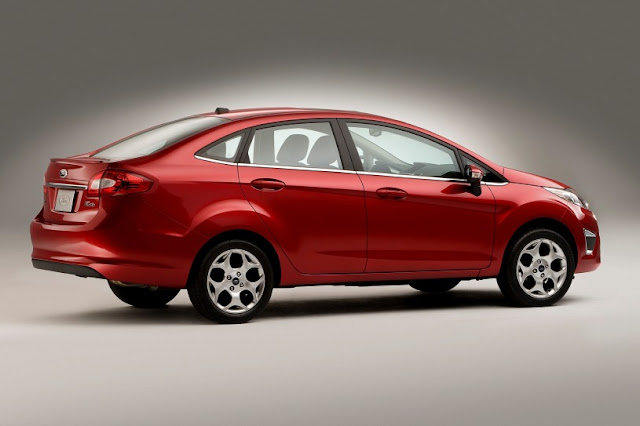 Side view of red 2011 Ford Fiesta sedan