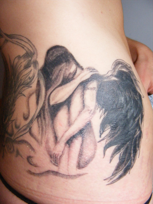 A black and grey dragon cover up thai tattoo studio style. dark angel tattoo