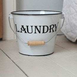 white bucket, says laundry