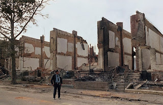 A policeman stands guard on Pine Street in West Philadelphia near the remains of 61 row houses days after they were destroyed by fire on May 13, 1985, when police dropped explosives into a house occupied by members of the radical group MOVE. George Widman/AP