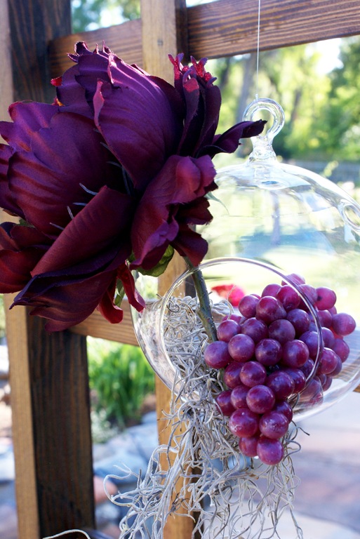 It was decorated with hanging glass bubbles flowers grapes and moss