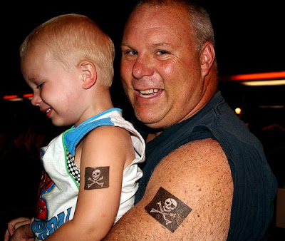cool family tattoo ideas father and his son look cool with skull tattoos.
