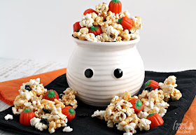 Candy pumpkins and ghost shaped sprinkles are tossed with peanut butter coated popcorn in this irresistible Haunted Pumpkin Patch Popcorn Crunch.