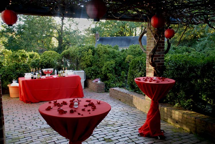 Red paper lanterns hung from the wisteria arbor carried out the color theme