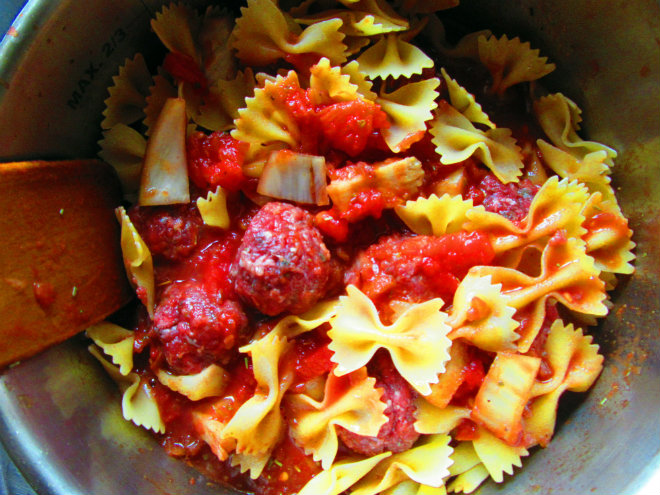 Pressure-cooker mini meatballs with farfalle by Laka kuharica: stir in and submerge pasta and meatballs in the sauce.