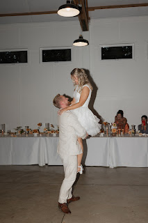 groom lifts bride during first dance