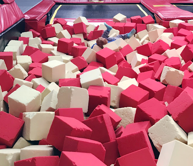 Little boy landing in a foam pit