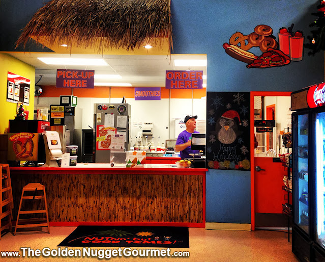 Man behind the counter of an indoor concession stand