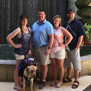 Photograph of me, dad, Kaitlyn and Tim in front of another fountain