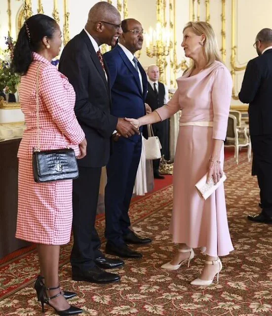 The Princess wore a white dress by Jenny Packham, Aquazzura slingback pumps, The Duchess wore a grecian dress by Suzannah