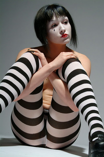 Mime, slim and topless, in light and shadow