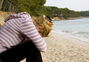 Girl crying in the beach - Stock Photo Credit: dnabil